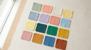 A minimalist, editorial-style photograph featuring a palette of harmonious, mood-boosting fabric swa