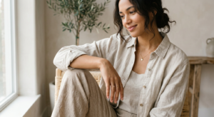 A professional editorial lifestyle photograph showing a close-up of a person wearing high-quality li